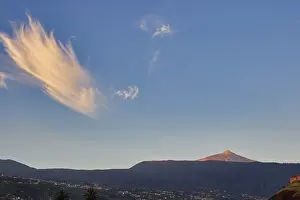 Deserted Volcanic Landscape Photography Prints: Panoramic view of volcano under blue sky with unique cloud formations