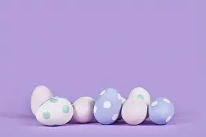 Easter Eggs Prints: Pastel colored easter eggs on violet background with copy space
