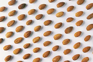 Light Colored Background Photography Prints: Pattern of almond nuts on a white background