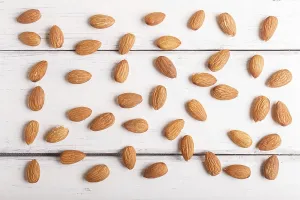 Healthy Eating Image Prints: Pattern and texture made from almonds on white wooden background