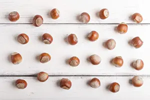 Vegan Diet Food Image Prints: Pattern and texture made from hazelnuts on white wooden background