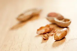 Wood Background Images Prints: Peanuts on wood background with dramatic lighting
