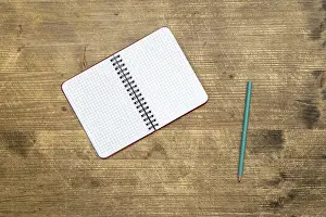 Uninhabited Study Space Prints: Pencil and open notebook on the table.Top view