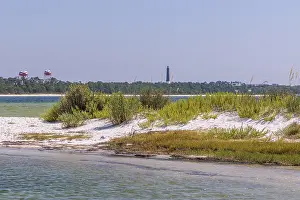 Prints of Pensacola lighthouse and the water towers of Naval Air Station Pensacola across the Pensacola Bay from Fort Pickens State Park at Pensacola Beach, Florida, USA Florida Prints: Pensacola Lighthouse Print Across Pensacola Bay
