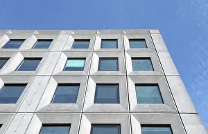 Prints of Perspective view of a white concrete office building against a bright blue sky with geometric brutalist 1960s details Brutalist Architecture Prints: Perspective View of a 1960s Brutalist Office Building Print