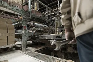 Construction Material Prints: Photo of worker in workshop for bricks production