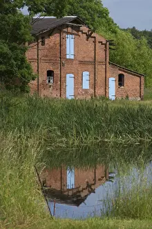 Deserted Livestock Farm Prints: Former pigsty reflected in the pond