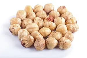 Vegan Diet Options Prints: Pile of hazelnuts isolated on white background