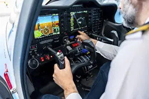 Air Traffic Transport Industry Prints: Pilot prepares for flight at the cockpit controls