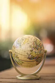 Rustic Table Setting Prints: Planning the next journey: miniature globe on a rustic table