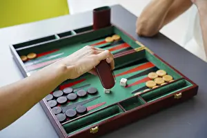 Classic Board Games Prints: A player makes a move in a backgammon game