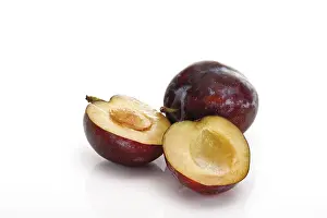 Studio Fruit Photography Prints: Plums, one is cut in half