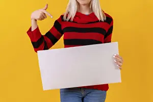 Yellow Studio Background Prints: Pointing to an empty ad poster