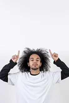 Young Man With Afro Hair Prints: Pointing above a copy paste space