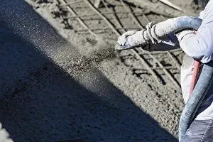 Construction Industry Workforce Prints: Pool construction worker shooting concrete