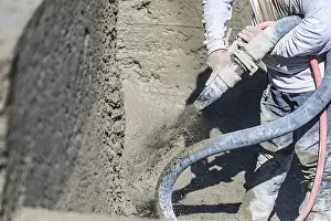 Swimming Pool Construction Site Prints: Pool construction worker shooting concrete
