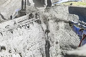 Concrete Pouring Techniques Prints: Pool construction worker shooting concrete