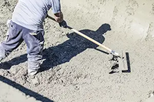 Building A Swimming Pool Prints: Pool construction worker working with A bullfloat on wet concrete