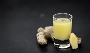 Shallow Depth Of Field Nature Shots Prints: Portion of fresh Ginger Juice (selective focus)