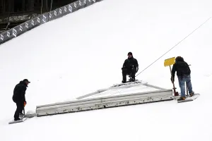 Ski Jumping World Cup Prints: Using an oversized rake attached to a cable winch