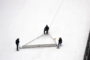 Ski Jumping World Cup Prints: Using an oversized rake attached to a cable winch