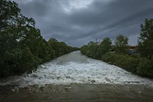 Uninhabited Waterfront Prints: A powerful river with a strong current under a cloudy sky