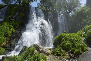 Powerful Waterfall Prints: A powerful waterfall flows over rocks