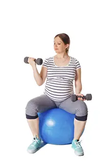 Pregnancy Exercise Prints: Pregnancy exercise concept, pregnant woman doing exercises with exercise ball and barbells isolated on white background