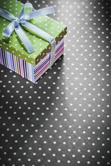 Decorative Still Life Photography Prints: Present box on red tablecloth vertical image holidays concept