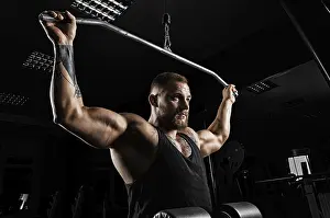 Athletic Training And Practice Prints: Professional athlete performs an exercise in the gym