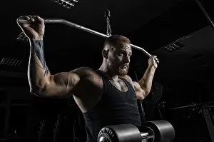 Athletic Training And Practice Prints: Professional athlete performs an exercise in the gym