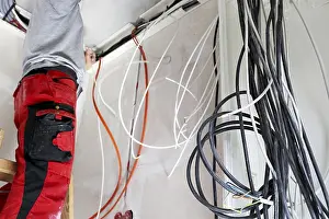 Construction Site Labourer Prints: Professional electrical installation on a building shell