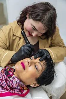 Permanent Makeup Prints: Professional technician using a microblading tool