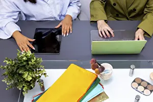 Professional Collaboration Prints: Two professionals collaborate using technology devices