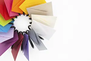 Empty Desk Utensils Prints: Propeller of colored envelopes on the white table