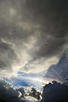 Low Angle Cloud View Prints: Rain clouds with sun breaking through