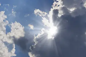 Sun Shining Through Clouds Prints: Rain clouds with sun shining through
