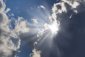 Cloudy Sky With Sunlight Prints: Rain clouds with sun shining through
