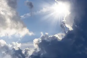 Sun Shining Through Clouds Prints: Rain clouds with sun shining through