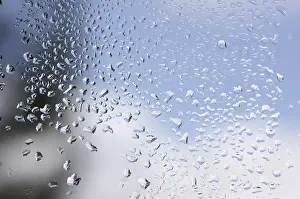 Raindrops On Window Prints: Rain drops on window as the clouds clear behind