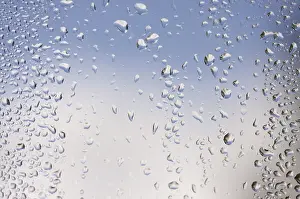 Overcast Sky Reflections Prints: Rain drops on window as the clouds clear behind