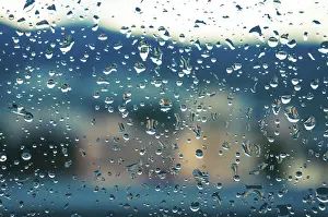 Evening Sunset Sky Prints: Rain drops on window glasses surface with sunset