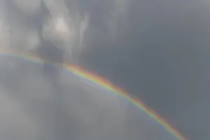 Rainbow In Rain Clouds Prints: Rainbow appears in rain clouds in spring