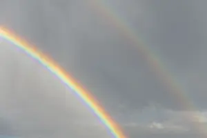 Rainbow In Rain Clouds Prints: Rainbow appears in rain clouds in spring