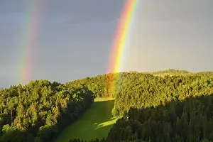 Deserted Forest Landscape Photo Prints: Rainbow in a hilly landscape with forest