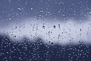 Rainy Window Prints: Raindrops on the window pane. Blue gradient on blurry background