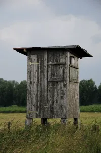Stormy Atmosphere Prints: Raised hide in front of storm clouds
