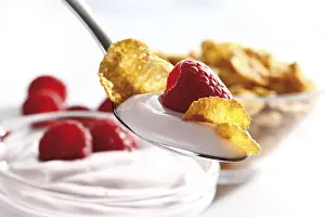 Close Up Breakfast Food Prints: Raspberry yoghurt with cornflakes on a spoon