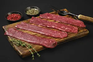 Black Background Food Prints: Raw beef strips on black background