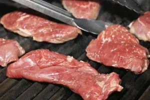 Gourmet Grilled Meat Prints: Raw steak on the grill